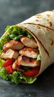 Delicious chicken wrap filled with fresh greens and tomatoes enjoyed in a cozy setting photo