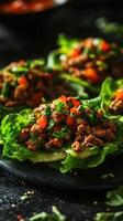 Fresh lettuce wraps filled with savory ground meat and vibrant toppings served on a dark plate photo