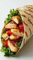 Grilled chicken wrap with fresh vegetables served in a toasted tortilla photo