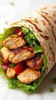 Delicious grilled chicken wrap with fresh vegetables and herbs prepared for a satisfying meal photo
