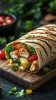 Delicious grilled chicken wrap with fresh vegetables and melted cheese served on a wooden board photo