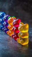 Colorful gummy bears arranged on a textured surface showcase vibrant hues in a delightful display photo