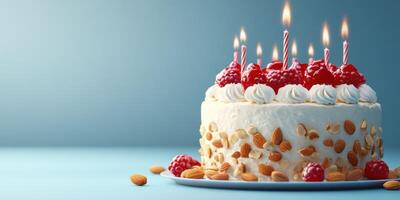Gorgeous cake with candles, raspberries, and almonds set on a blue background for a birthday celebration photo