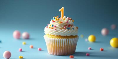 Colorful cupcake with a number one candle surrounded by candies on a blue background celebrating a first birthday photo