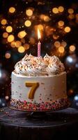 Seven birthday cake with a single candle and colorful sprinkles glowing in soft lights for a joyful celebration photo