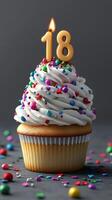 Celebratory cupcake adorned with an 18 candle and colorful sprinkles, perfect for a birthday party photo