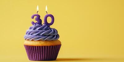 Celebrating a milestone with a delicious cupcake featuring purple frosting and a 30 birthday candle photo