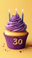 Celebrate a milestone birthday with a colorful cupcake adorned with candles and vibrant icing photo