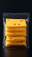 Slices of yellow cheese packed neatly in clear plastic for fresh storage and easy access at any time photo