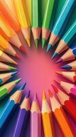 Vibrant colored pencils arranged in a circular pattern on a colorful surface creating a cheerful atmosphere photo