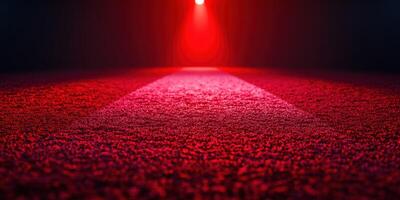 Bright red lighting illuminates a textured surface in a dramatic composition during nighttime photo