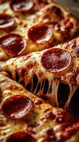 Delicious cheesy pepperoni pizza slices with melted cheese pulled apart on a rustic wooden table photo