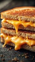 Delicious grilled cheese sandwich stacked with melty cheese on a dark background photo