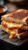Melty grilled cheese sandwich with golden crust served on rustic wooden board photo