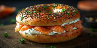 Freshly made bagel sandwich with smoked salmon and cream cheese on a wooden board photo