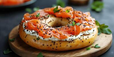 Delicious bagel topped with smoked salmon, cream cheese, and herbs served on a wooden board photo