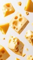 Yellow cheese cubes floating in mid-air with a simple background showcasing their textures and shapes photo