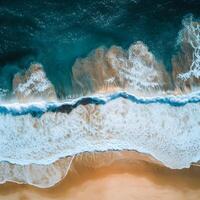Aerial view of ocean waves crashing on the sandy beach at sunset. Abstract background with waves. photo