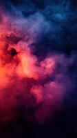 Colorful abstract smoke swirling together in a dynamic display of reds, blues, and purples against a dark background photo