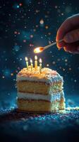 Celebration cake adorned with candles and colorful sprinkles, lit by a hand preparing for a special moment photo