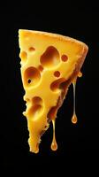 Cheddar cheese slice oozing with melted goodness floating against black background photo