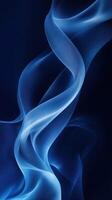 Soft blue fabric creates elegant flowing shapes against a dark background in a serene composition photo