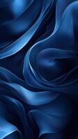 Swirling blue silk fabric creating a soft, flowing texture in a deep shadowed composition photo