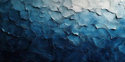 Textured blue wall with layers of paint and plaster showcasing a gradient effect from light to dark photo