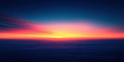 Vibrant sunset hues illuminate the horizon over the calm ocean during twilight hours photo
