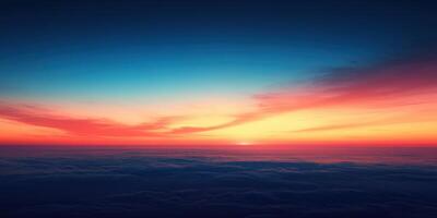 Colorful sunset over clouds viewed from a high altitude showcasing vibrant hues of orange, pink, and blue photo