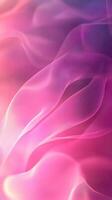 Colorful flowing fabric creates a soft abstract background with pink and purple hues photo