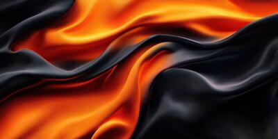 Silky black and orange fabric drapes elegantly with smooth folds under soft lighting in a cozy setting photo