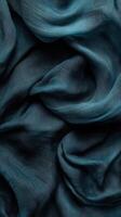 Soft teal fabric draped artfully, creating elegant folds and shadows under soft lighting in a creative space photo