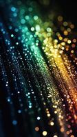 Colorful light patterns create a vibrant display of shimmering droplets in a dark background setting photo