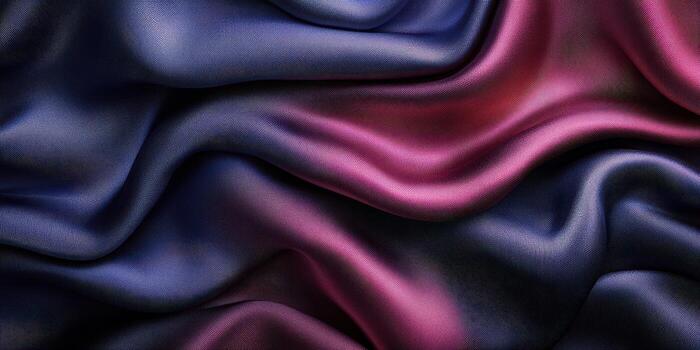 Luxurious silk fabric draping in rich purple and deep red tones creates an elegant textile view in soft light photo