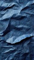 Crumpled blue paper texture showcasing intricate folds and shadows for artistic design photo