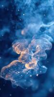Swirling blue and gold abstract pattern with luminous particles in dark background photo