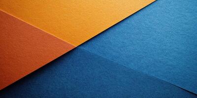 Colorful textured paper sheets arranged at an angle showcasing vibrant blue and orange hues in a creative workspace photo