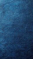 Textured blue fabric surface illustrating intricate patterns and colors under soft light photo
