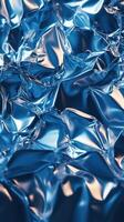 Shimmering blue foil texture with intricate patterns highlighted by light reflections photo
