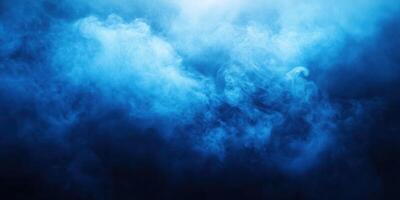 Soft blue smoke swirls in a dark atmosphere creating a mysterious ambiance for creative backgrounds and effects photo