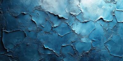 Textured blue wall with cracks displaying variation in shades and tones photo