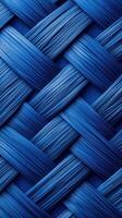 Textured blue braided pattern in a close-up view showing intricate weaving details and smooth surface photo