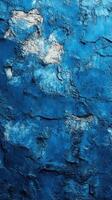 Textured blue wall showing cracks and imperfections in a rustic urban setting photo