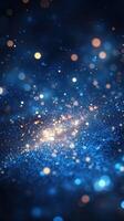 Sparkling blue and gold particles floating in a cosmic scene at night photo