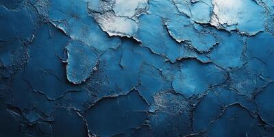 Cracked blue wall texture featuring vibrant shades and unique patterns illuminated by natural light in an artistic setting photo