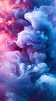 Colorful abstract smoke swirling in shades of pink and blue creates a captivating visual effect in a dark atmosphere photo