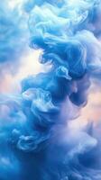 Colorful blue smoke spirals and swirls against a soft gradient background creating an abstract art piece photo