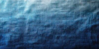 Deep blue fabric texture showcasing a gradient from light to dark shades in natural light photo