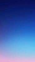 Vibrant twilight sky transitions from deep blue to soft pink at dusk near the horizon photo